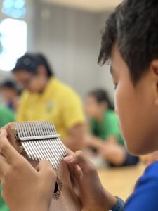 Boy from Vinnie Classroom playing Kalimba